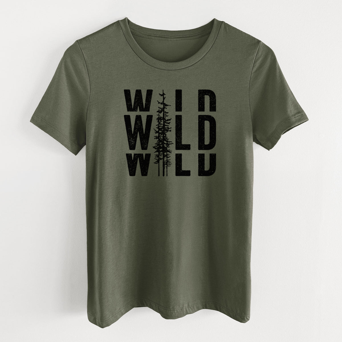 Military green women's relaxed fit cotton t-shirt laid flat, printed with bold black text reading WILD stacked three times, with a tall pine tree forming the letter I.