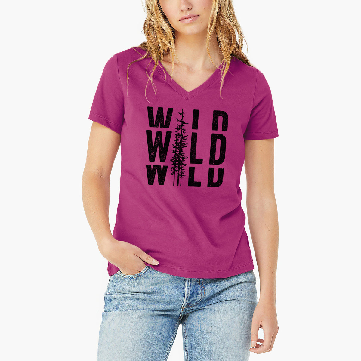 Woman wearing a berry pink women's relaxed fit cotton V-neck t-shirt printed with bold black text reading WILD stacked three times, with a tall pine tree forming the letter I.