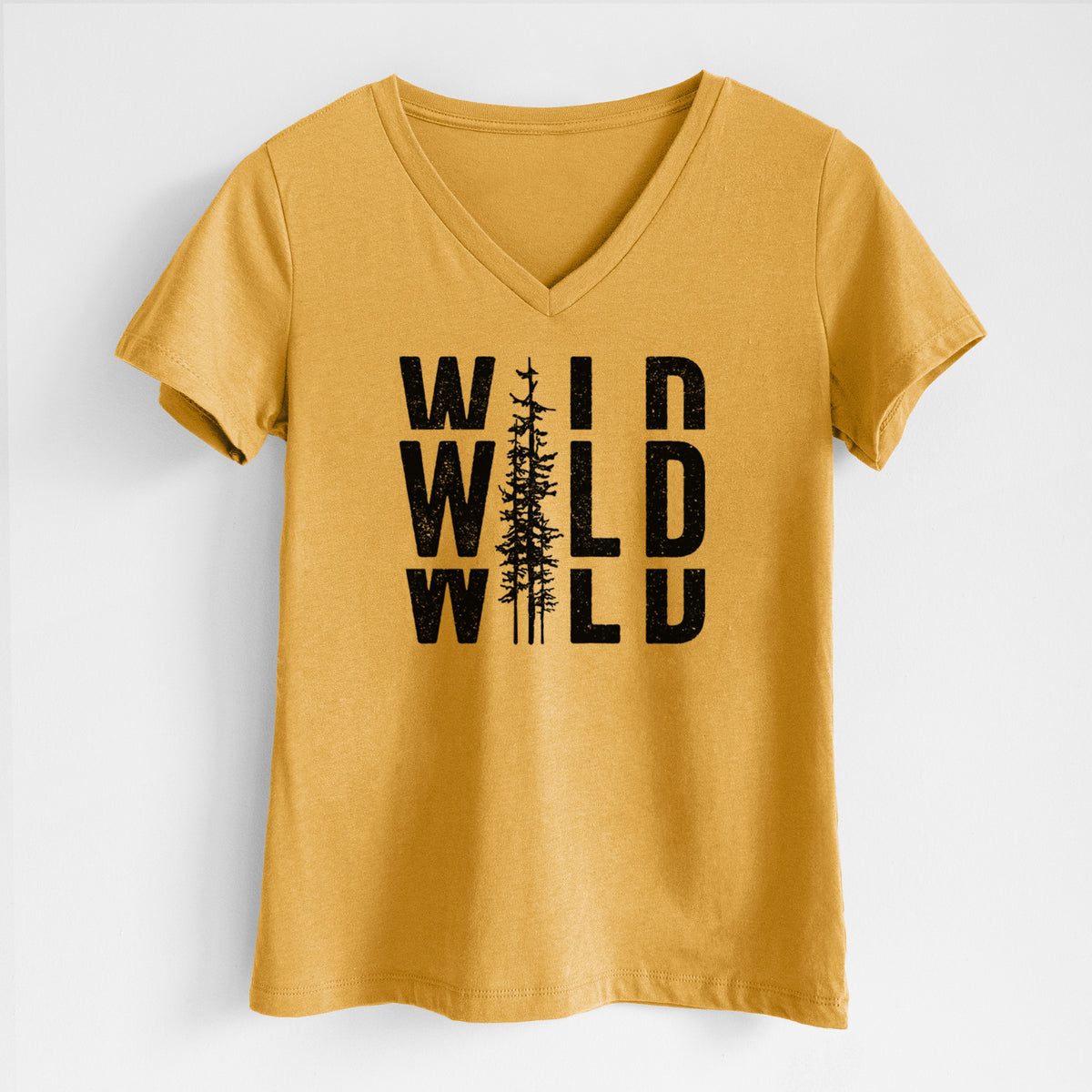 Honeycomb yellow women's relaxed fit cotton V-neck t-shirt laid flat, printed with bold black text reading WILD stacked three times, with a tall pine tree forming the letter I.