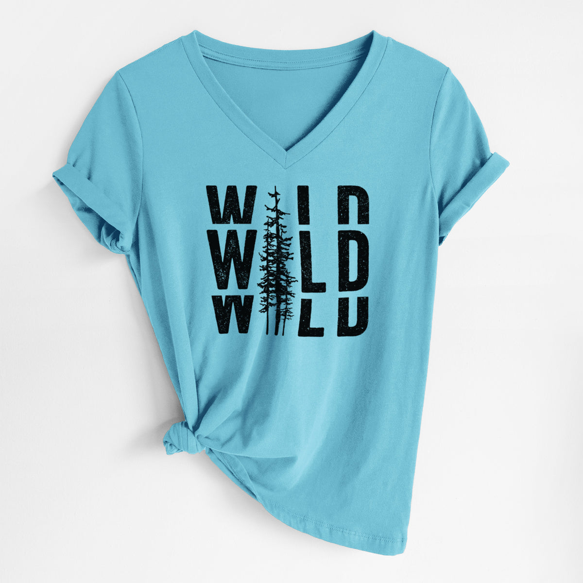 Turquoise women's relaxed fit cotton V-neck t-shirt laid flat, printed with bold black text reading WILD stacked three times, with a tall pine tree forming the letter I.