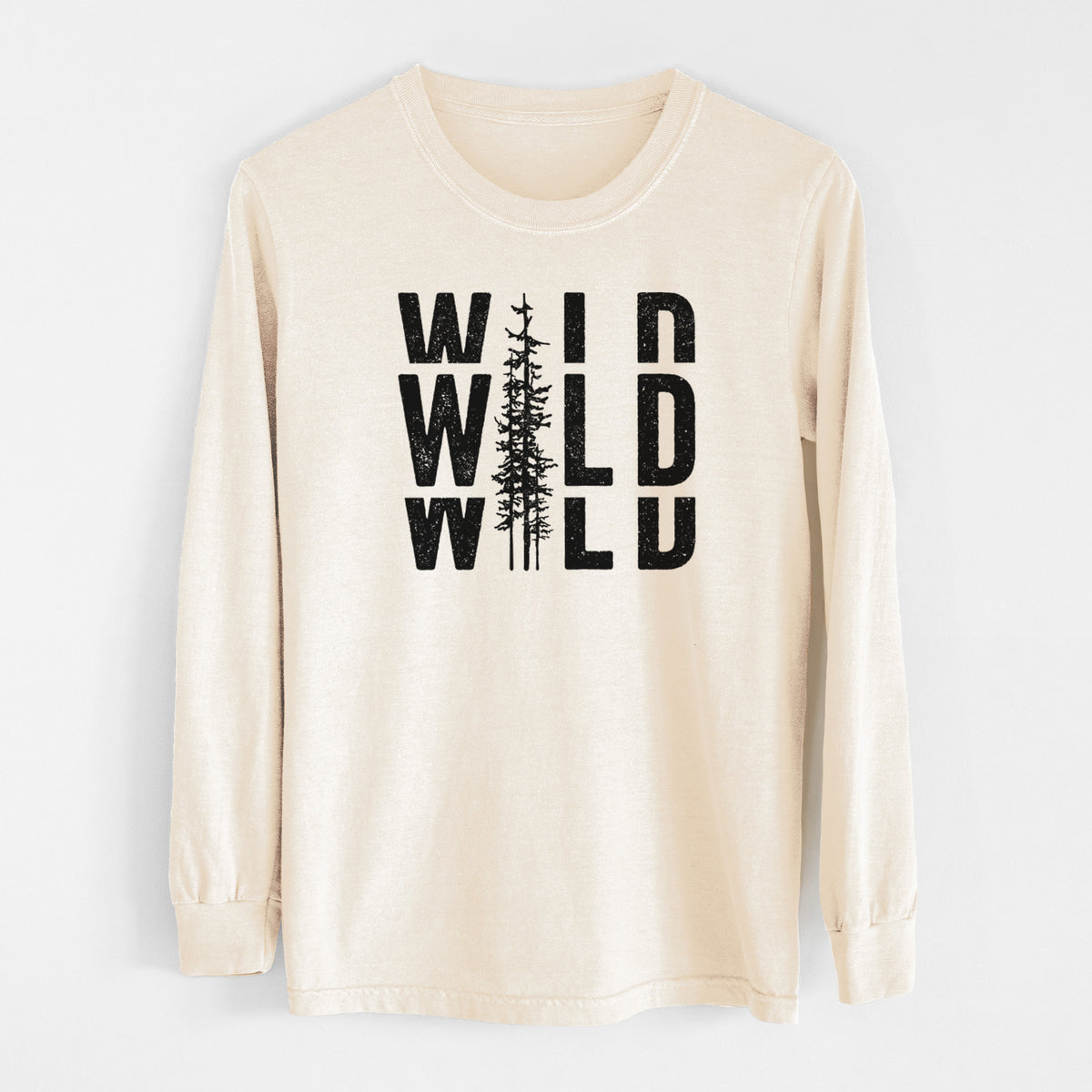 Ivory Comfort Colors long sleeve shirt laid flat, printed with bold black text reading WILD stacked three times, with a tall pine tree forming the letter I.