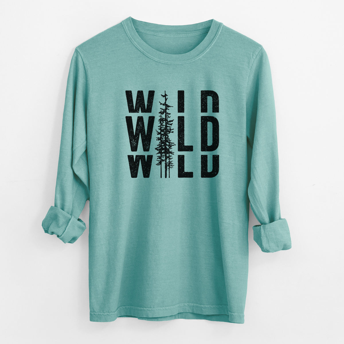 Reef green Comfort Colors long sleeve shirt laid flat with the cuffs rolled, printed with bold black text reading WILD stacked three times, with a tall pine tree forming the letter I.