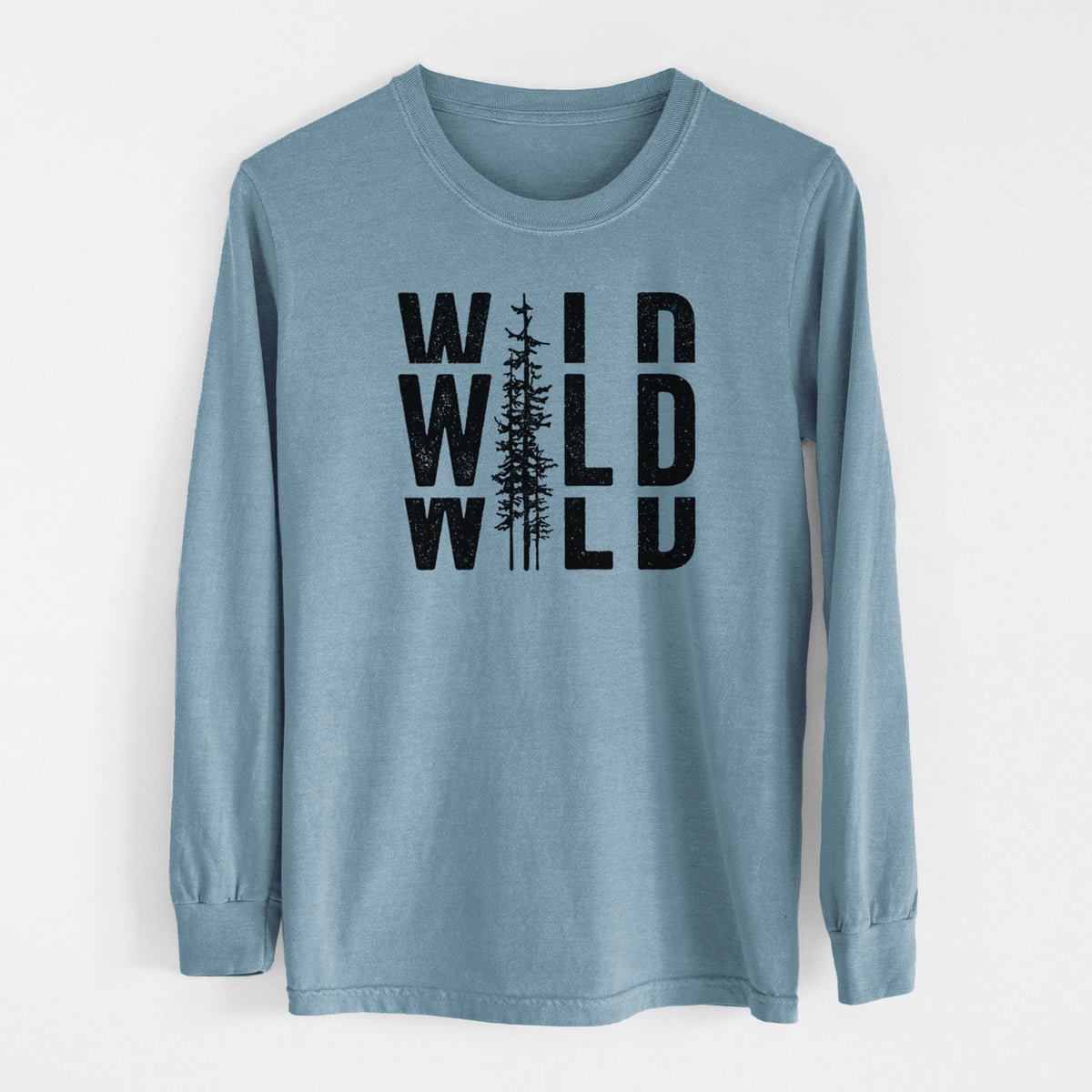 Steel blue Comfort Colors long sleeve shirt laid flat, printed with bold black text reading WILD stacked three times, with a tall pine tree forming the letter I.