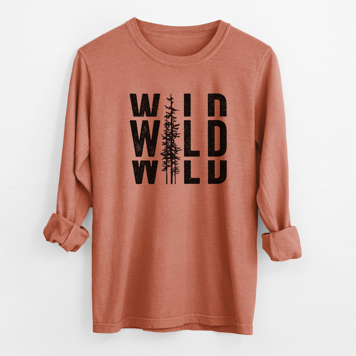 Yam burnt orange Comfort Colors long sleeve shirt laid flat with the cuffs rolled, printed with bold black text reading WILD stacked three times, with a tall pine tree forming the letter I.