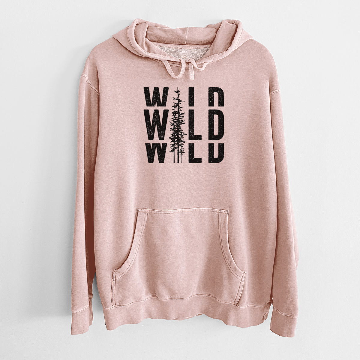 Dusty pink pigment dyed hoodie laid flat, printed with bold black text reading WILD stacked three times, with a tall pine tree forming the letter I.