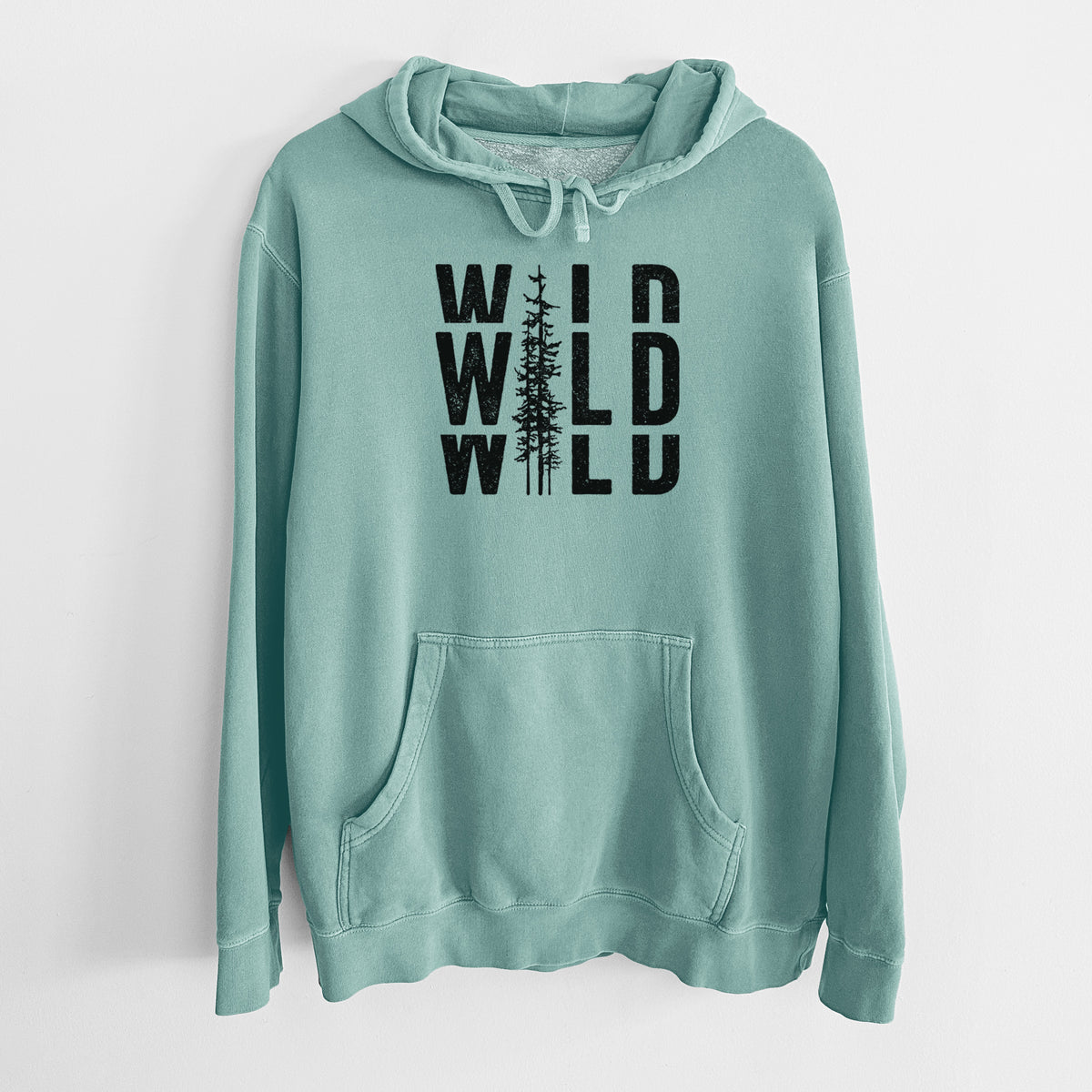 Mint green pigment dyed hoodie laid flat, printed with bold black text reading WILD stacked three times, with a tall pine tree forming the letter I.