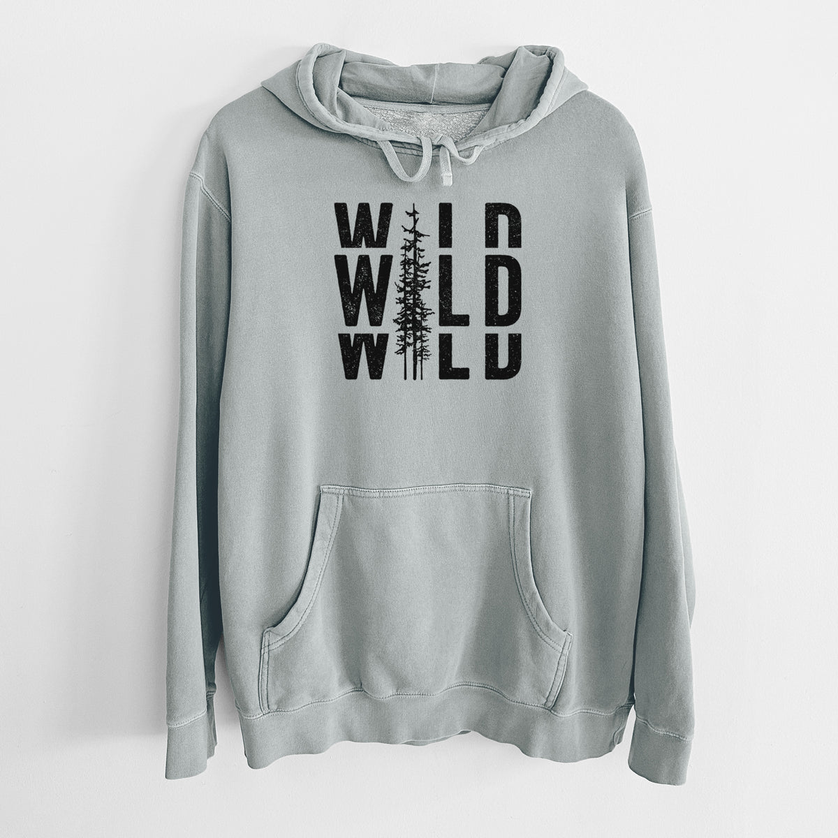 Sage green pigment dyed hoodie laid flat, printed with bold black text reading WILD stacked three times, with a tall pine tree forming the letter I.