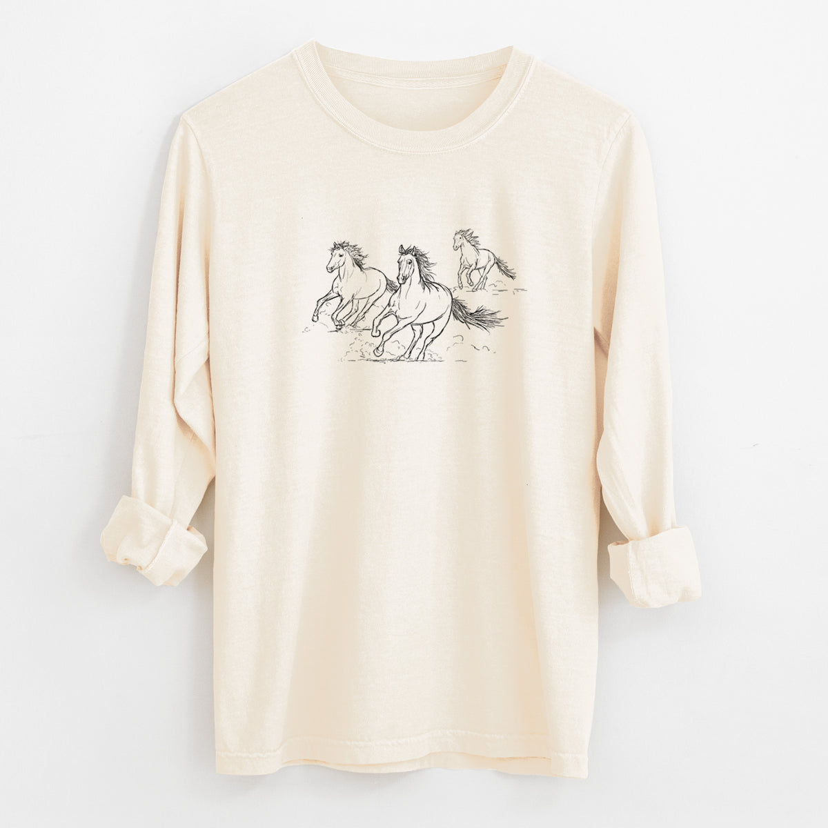 Ivory Comfort Colors long sleeve shirt laid flat with the cuffs rolled, printed with a black ink illustration of three wild horses galloping.