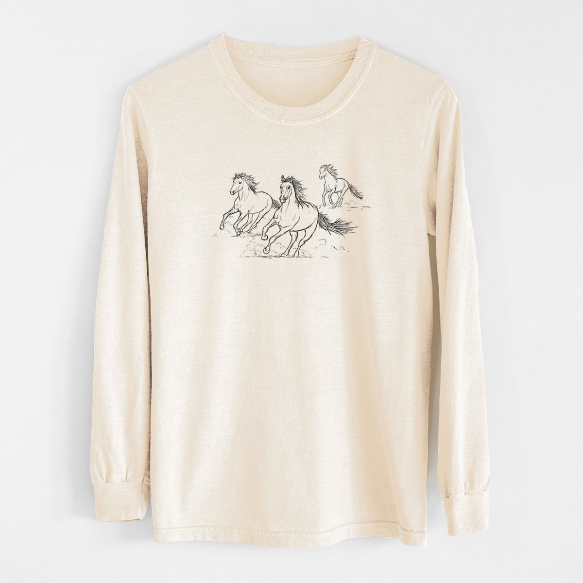 Ivory Comfort Colors long sleeve shirt laid flat, printed with a black ink illustration of three wild horses galloping.