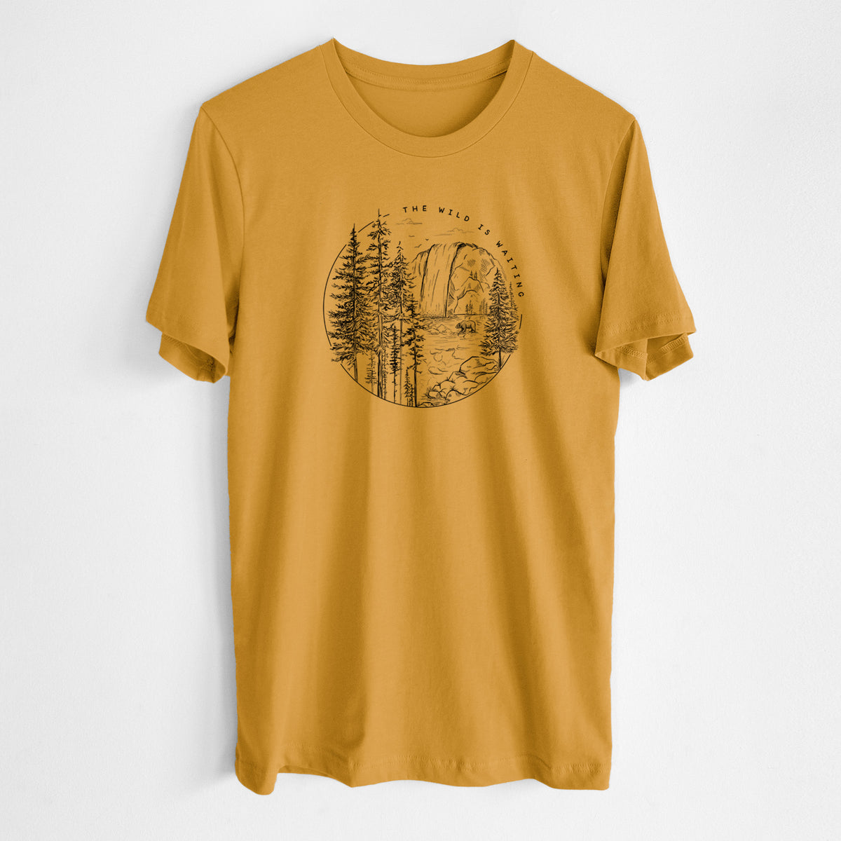 Honeycomb yellow lightweight cotton t-shirt laid flat, printed with a round black ink scene of a waterfall, pine trees and a river, with the words The Wild Is Waiting.