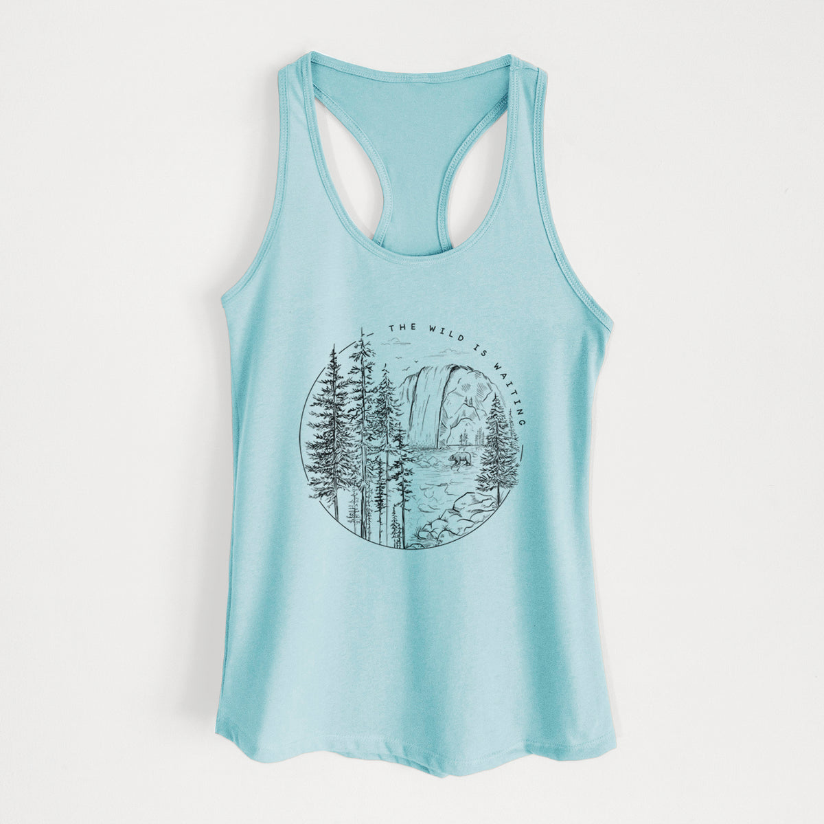 Cancun blue women's racerback tank top laid flat, printed with a round black ink scene of a waterfall, pine trees and a river, with the words The Wild Is Waiting.