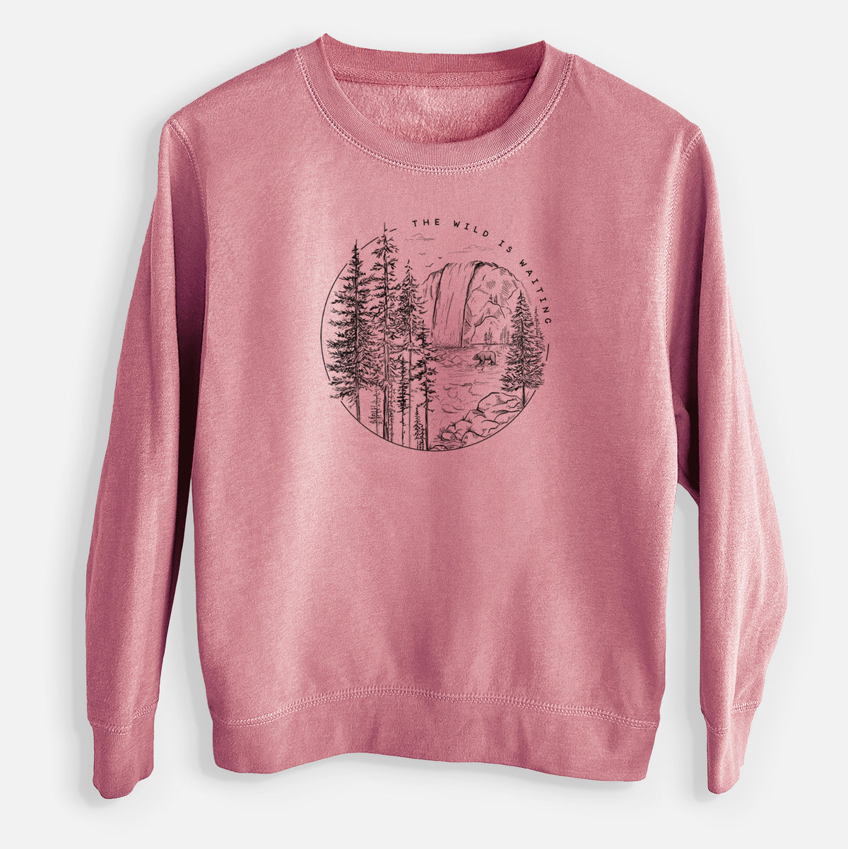 Mauve pink youth crewneck sweatshirt laid flat, printed with a round black ink scene of a waterfall, pine trees and a river, with the words The Wild Is Waiting.