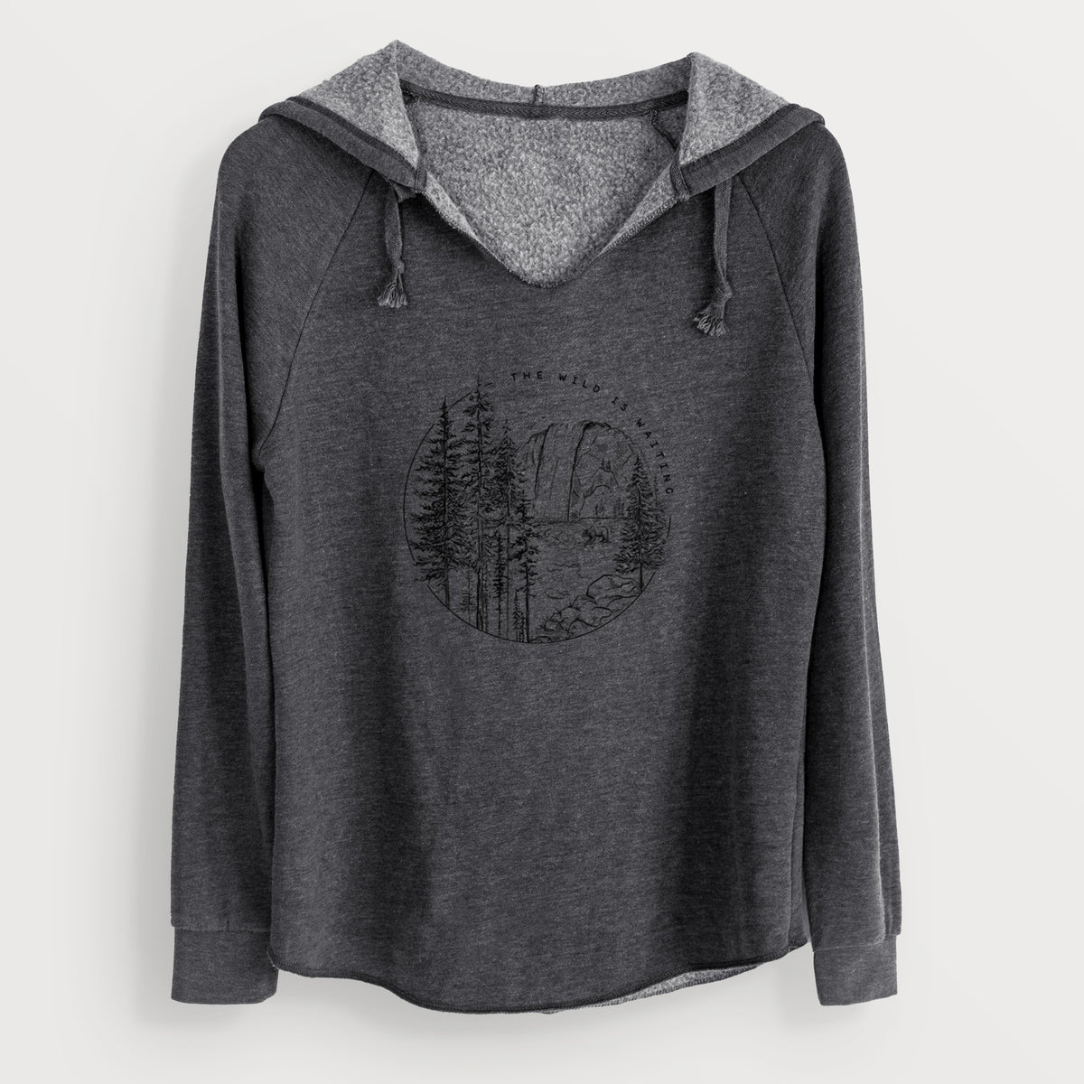 Charcoal grey women's Cali Wave hooded sweatshirt laid flat, printed with a round black ink scene of a waterfall, pine trees and a river, with the words The Wild Is Waiting.