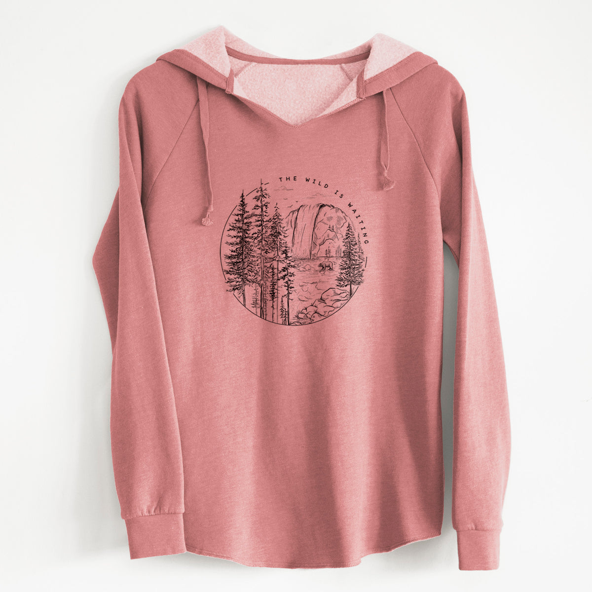 Dusty rose women's Cali Wave hooded sweatshirt laid flat, printed with a round black ink scene of a waterfall, pine trees and a river, with the words The Wild Is Waiting.