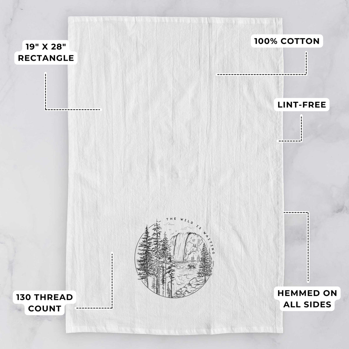 White tea towel printed with a round black ink scene of a waterfall, pine trees and a river, with the words The Wild Is Waiting, with feature labels: 19 by 28 inch rectangle, 100% cotton, lint-free, 130 thread count, hemmed on all sides.