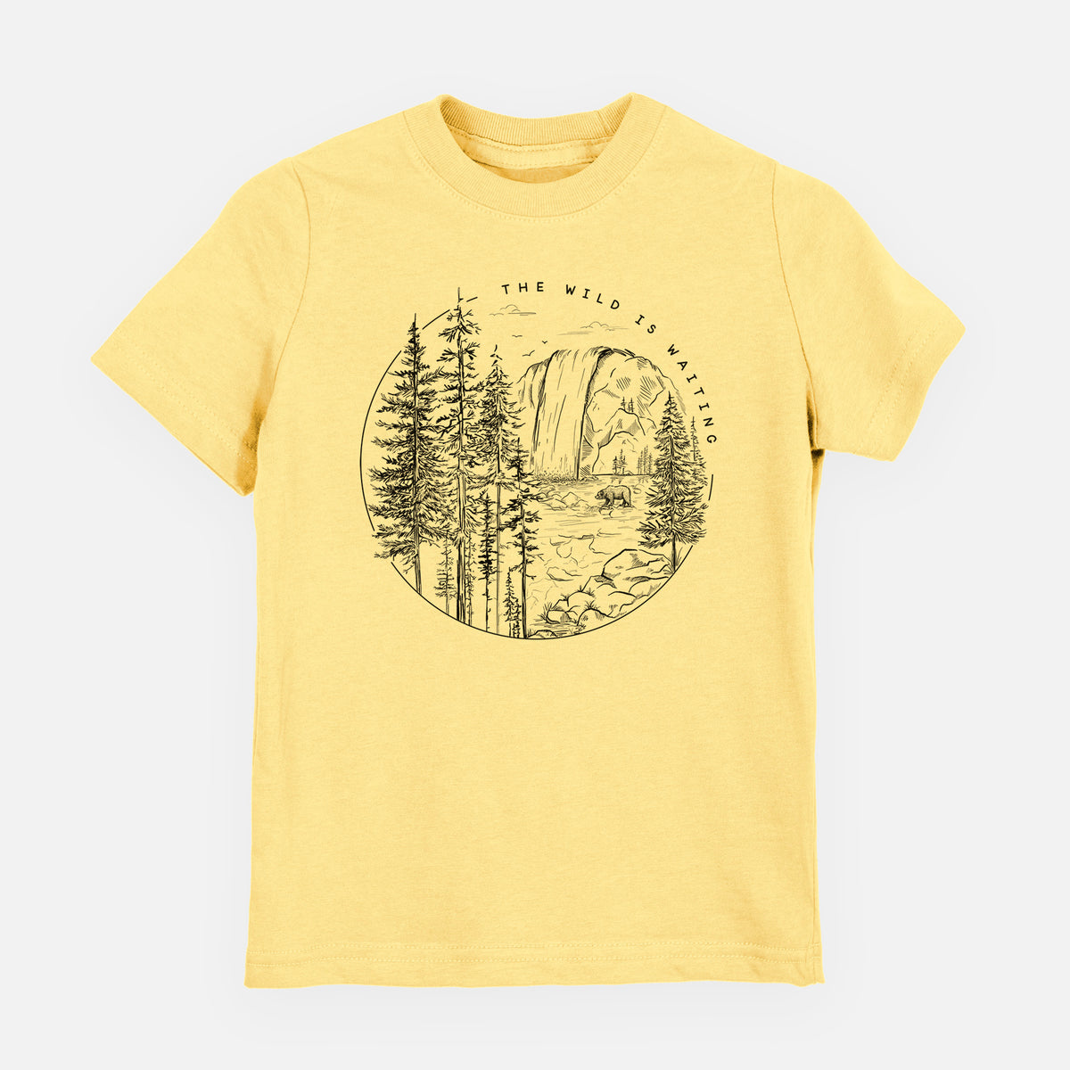 Butter yellow youth t-shirt laid flat, printed with a round black ink scene of a waterfall, pine trees and a river, with the words The Wild Is Waiting.