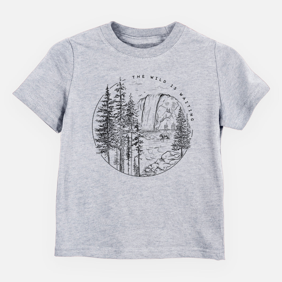 Heather grey toddler t-shirt laid flat, printed with a round black ink scene of a waterfall, pine trees and a river, with the words The Wild Is Waiting.