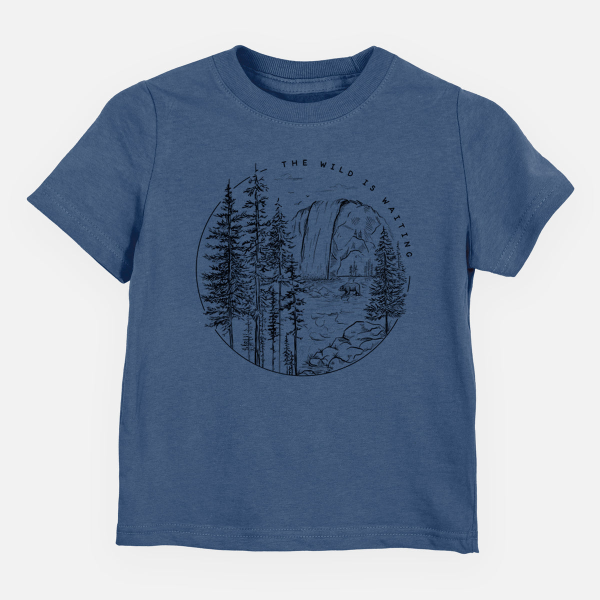 Indigo blue toddler t-shirt laid flat, printed with a round black ink scene of a waterfall, pine trees and a river, with the words The Wild Is Waiting.