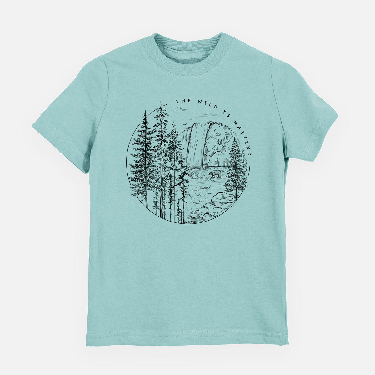 Saltwater youth t-shirt laid flat, printed with a round black ink scene of a waterfall, pine trees and a river, with the words The Wild Is Waiting.