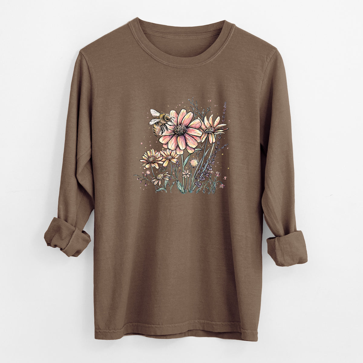 Espresso brown Comfort Colors long sleeve shirt laid flat with the cuffs rolled, printed with a soft full-color illustration of a bee flying over pink and purple wildflowers.