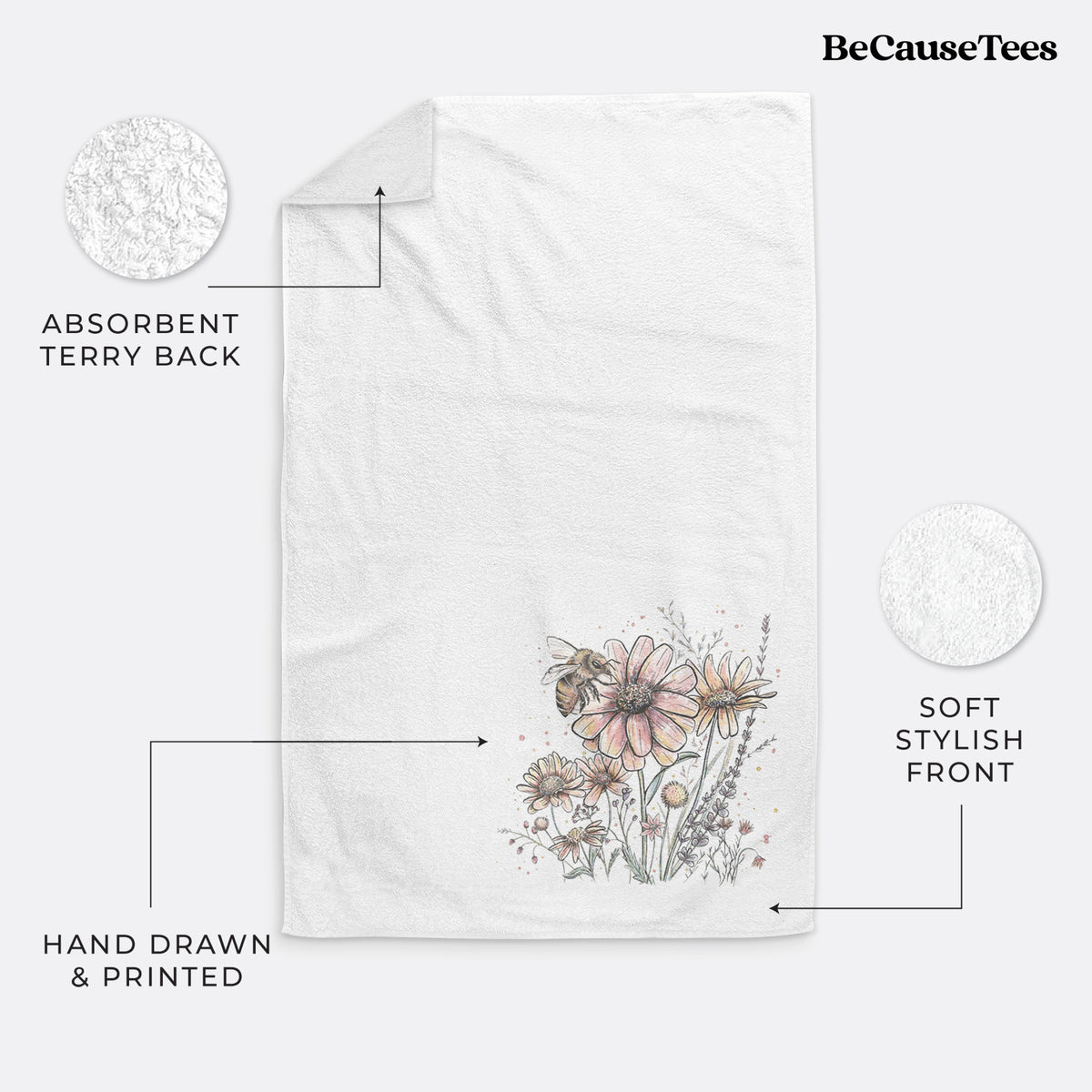 White hand towel printed with a soft full-color illustration of a bee flying over pink and purple wildflowers.