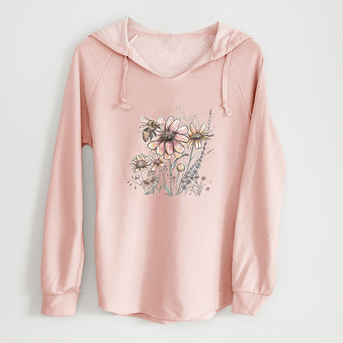 Blush pink women's Cali Wave hooded sweatshirt laid flat, printed with a soft full-color illustration of a bee flying over pink and purple wildflowers.
