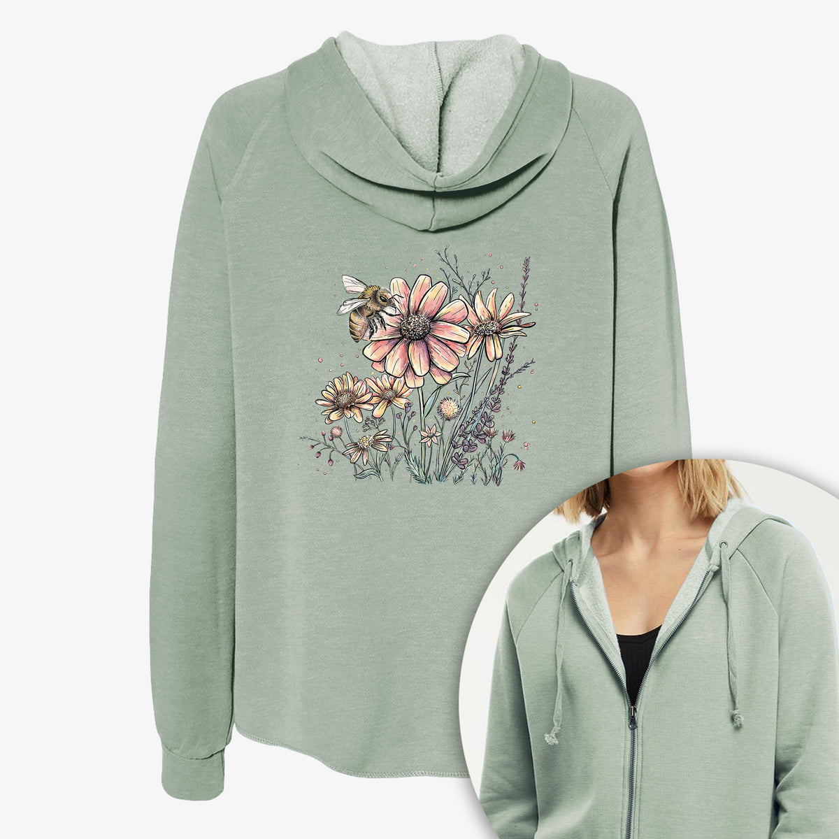 Women's Cali Wave zip-up sweatshirt printed with a soft full-color illustration of a bee flying over pink and purple wildflowers, with a close-up of the zipper.