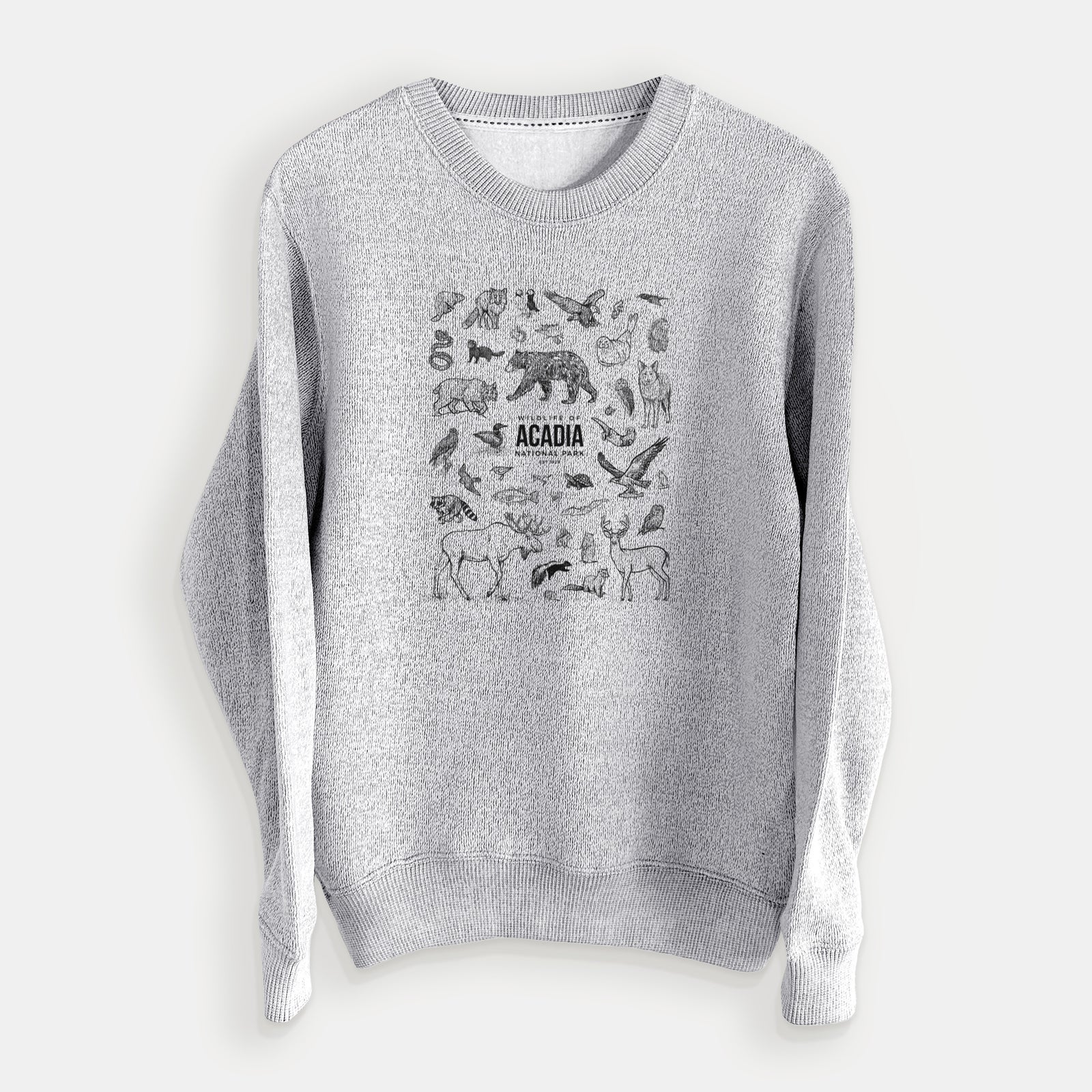 Salt and pepper knit sweatshirt laid flat, printed with a collection of black ink wildlife illustrations surrounding the words Acadia National Park.