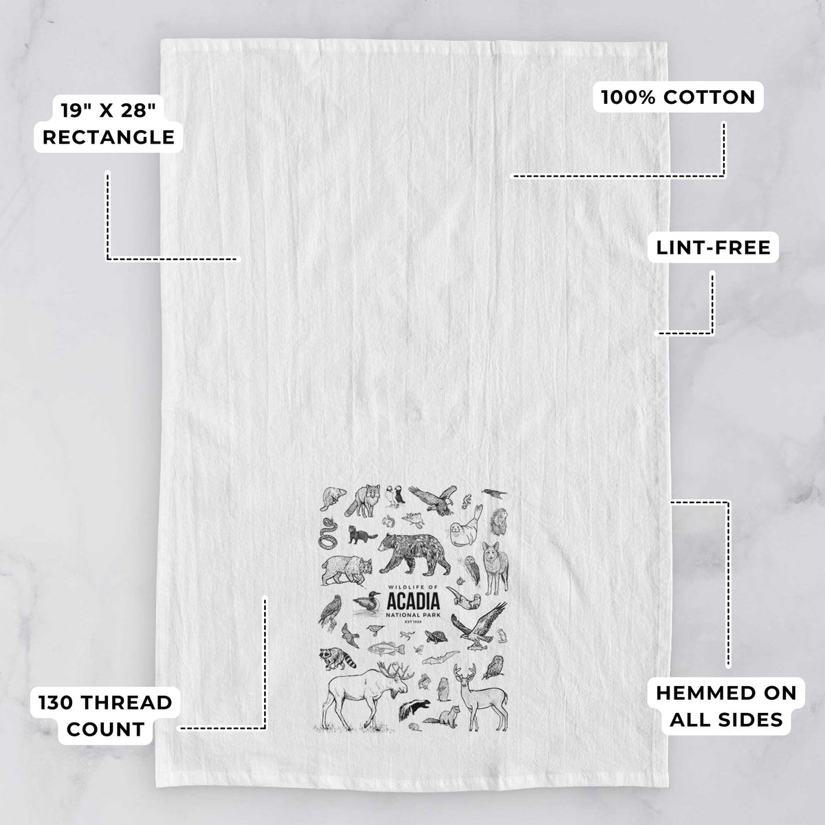 White tea towel printed with a collection of black ink wildlife illustrations surrounding the words Acadia National Park, with feature labels: 19 by 28 inch rectangle, 100% cotton, lint-free, 130 thread count, hemmed on all sides.