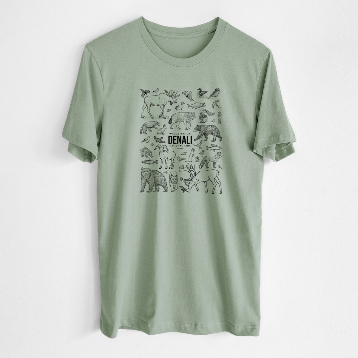 Sage green lightweight cotton t-shirt laid flat, printed with a collection of black ink wildlife illustrations surrounding the words Denali National Park.