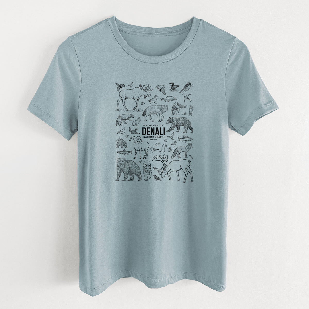 Vintage denim women's relaxed fit cotton t-shirt laid flat, printed with a collection of black ink wildlife illustrations surrounding the words Denali National Park.