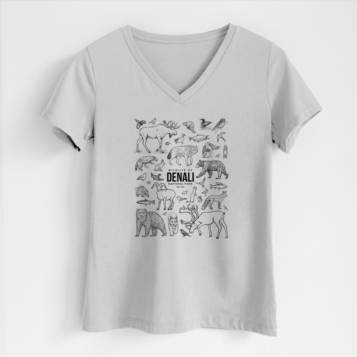 Lunar grey women's relaxed fit cotton V-neck t-shirt laid flat, printed with a collection of black ink wildlife illustrations surrounding the words Denali National Park.