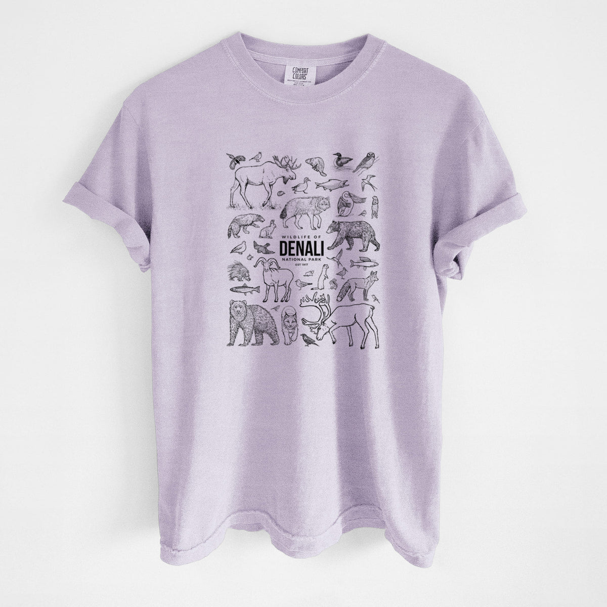 Orchid purple Comfort Colors t-shirt laid flat, printed with a collection of black ink wildlife illustrations surrounding the words Denali National Park.
