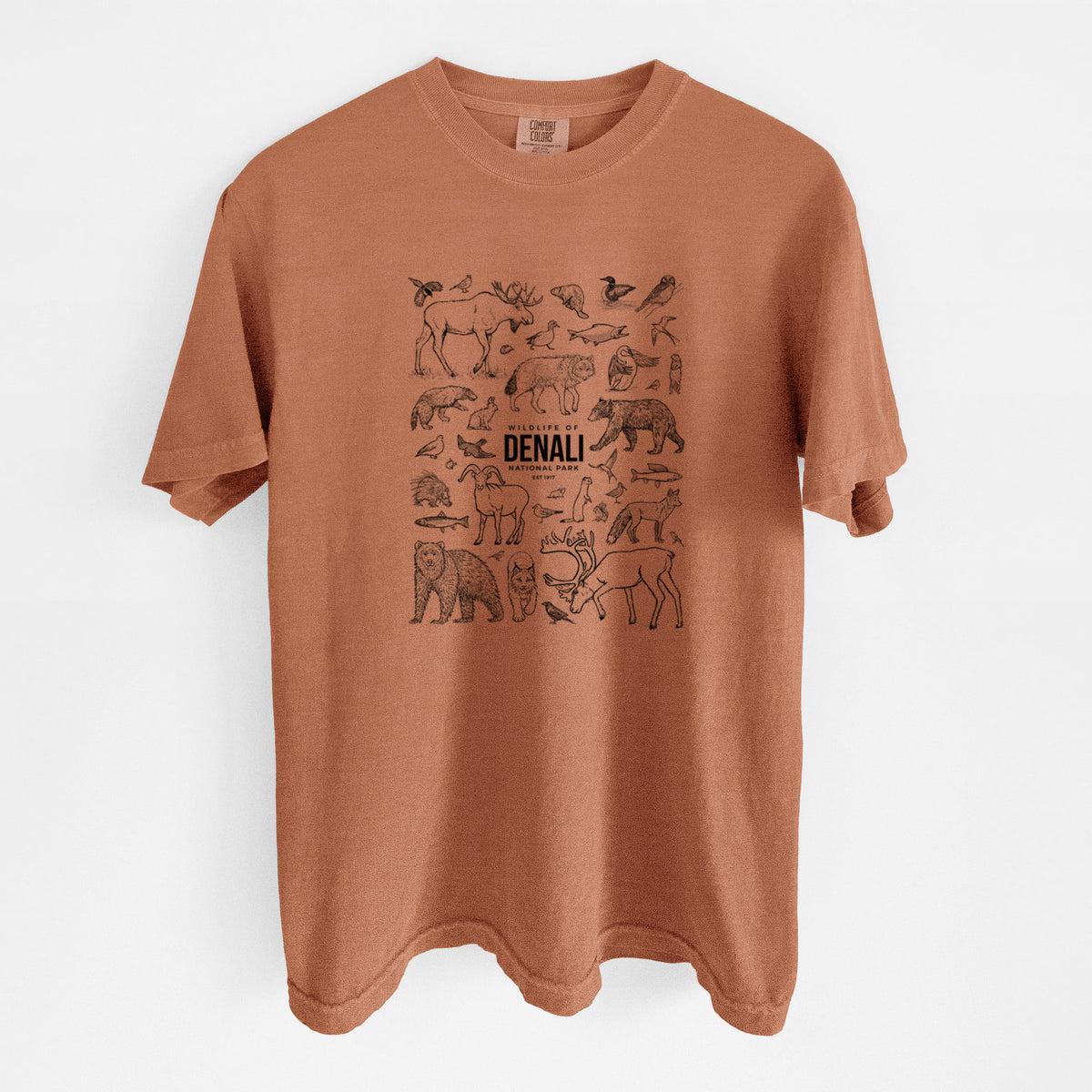 Yam burnt orange Comfort Colors t-shirt laid flat, printed with a collection of black ink wildlife illustrations surrounding the words Denali National Park.
