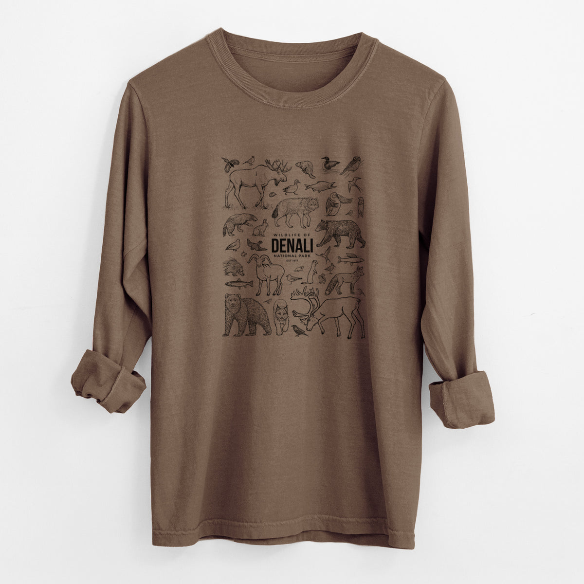 Espresso brown Comfort Colors long sleeve shirt laid flat with the cuffs rolled, printed with a collection of black ink wildlife illustrations surrounding the words Denali National Park.