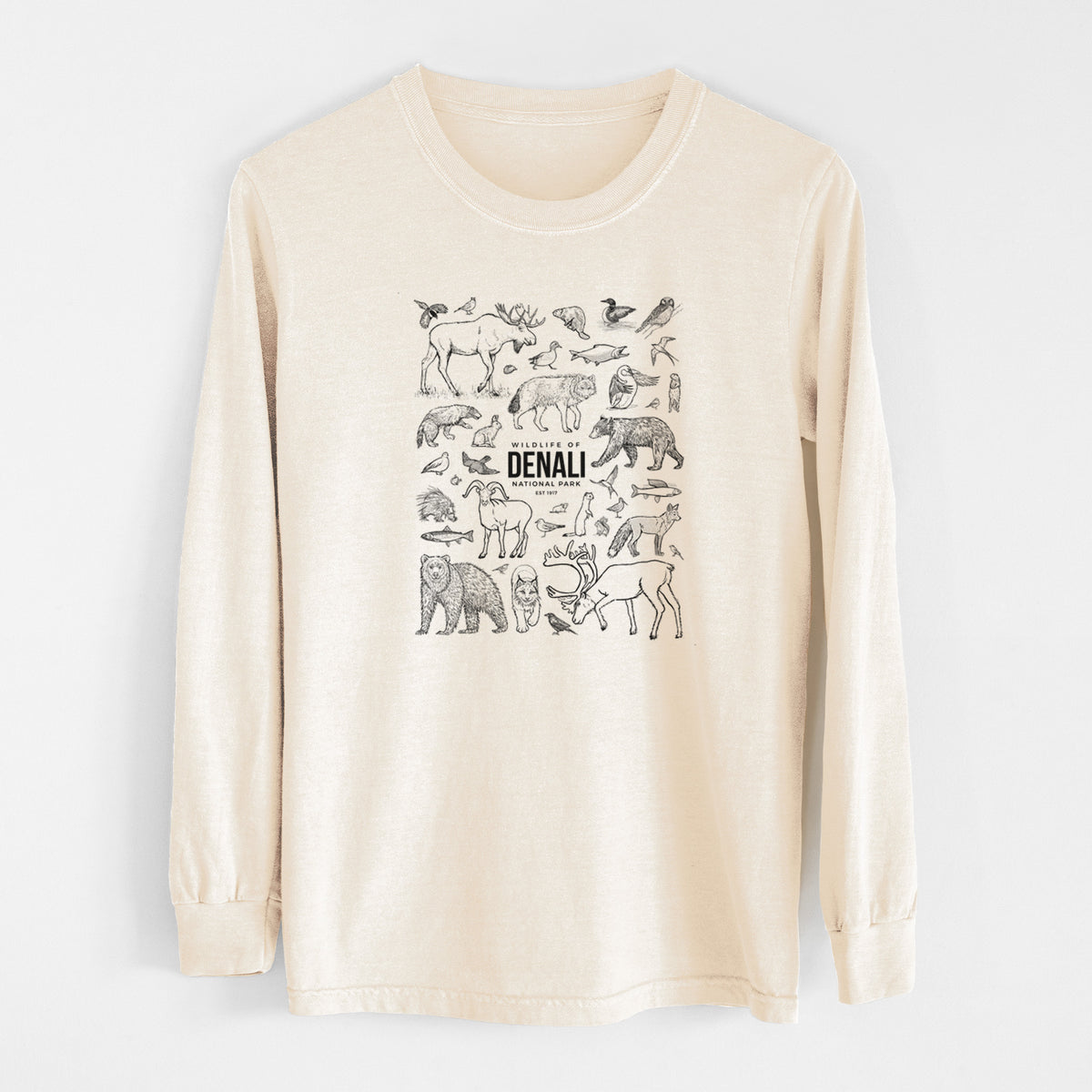 Ivory Comfort Colors long sleeve shirt laid flat, printed with a collection of black ink wildlife illustrations surrounding the words Denali National Park.