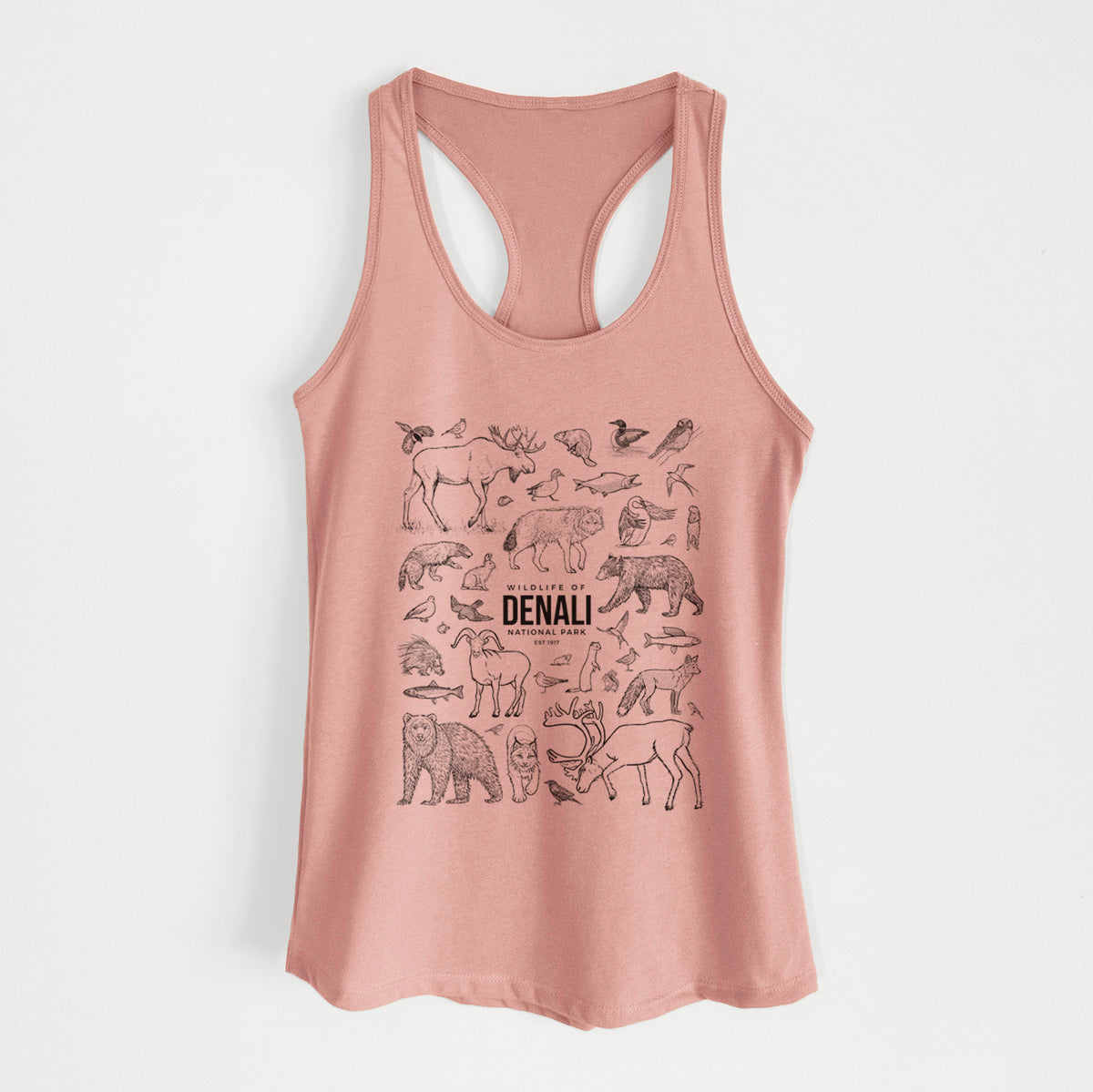 Desert pink women's racerback tank top laid flat, printed with a collection of black ink wildlife illustrations surrounding the words Denali National Park.