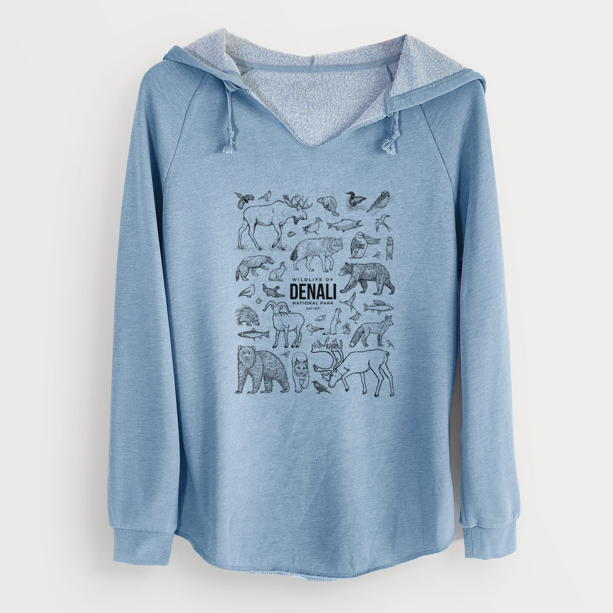 Misty blue women's Cali Wave hooded sweatshirt laid flat, printed with a collection of black ink wildlife illustrations surrounding the words Denali National Park.