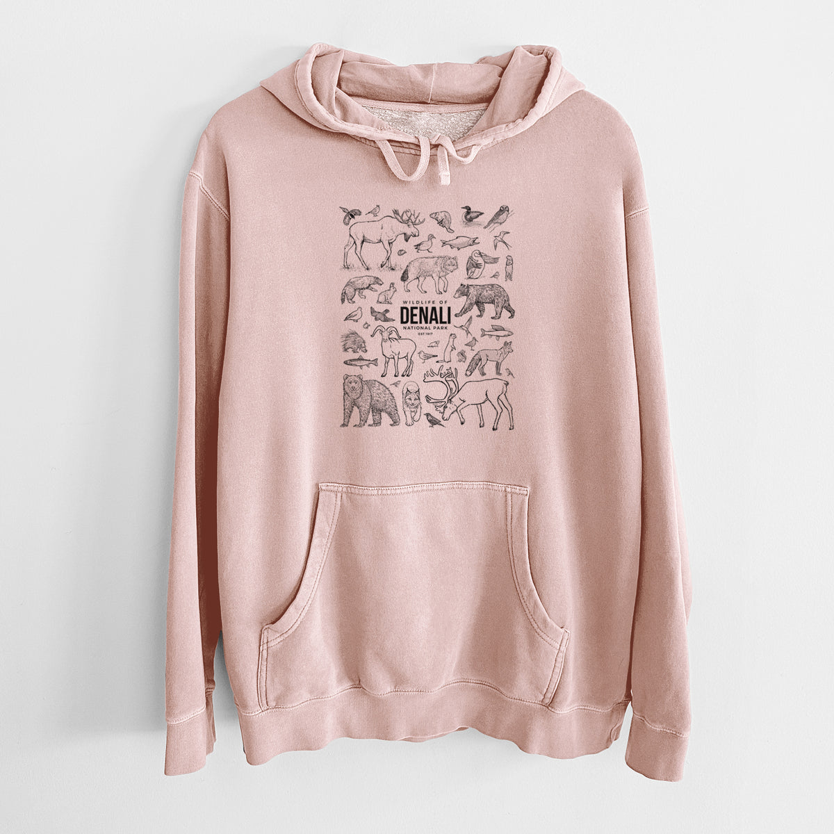 Dusty pink pigment dyed hoodie laid flat, printed with a collection of black ink wildlife illustrations surrounding the words Denali National Park.
