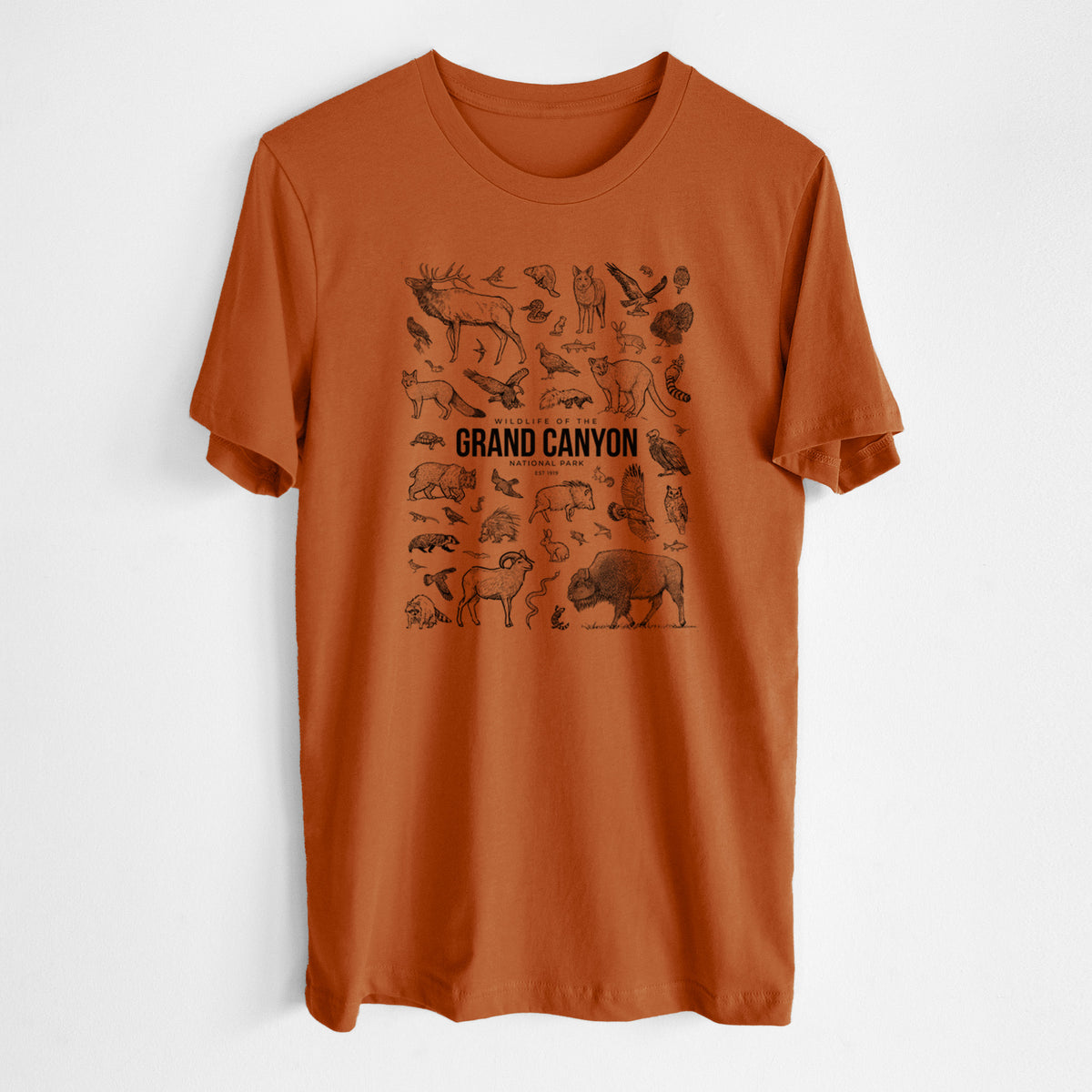 Autumn lightweight cotton t-shirt laid flat, printed with a collection of black ink wildlife illustrations surrounding the words Grand Canyon National Park.