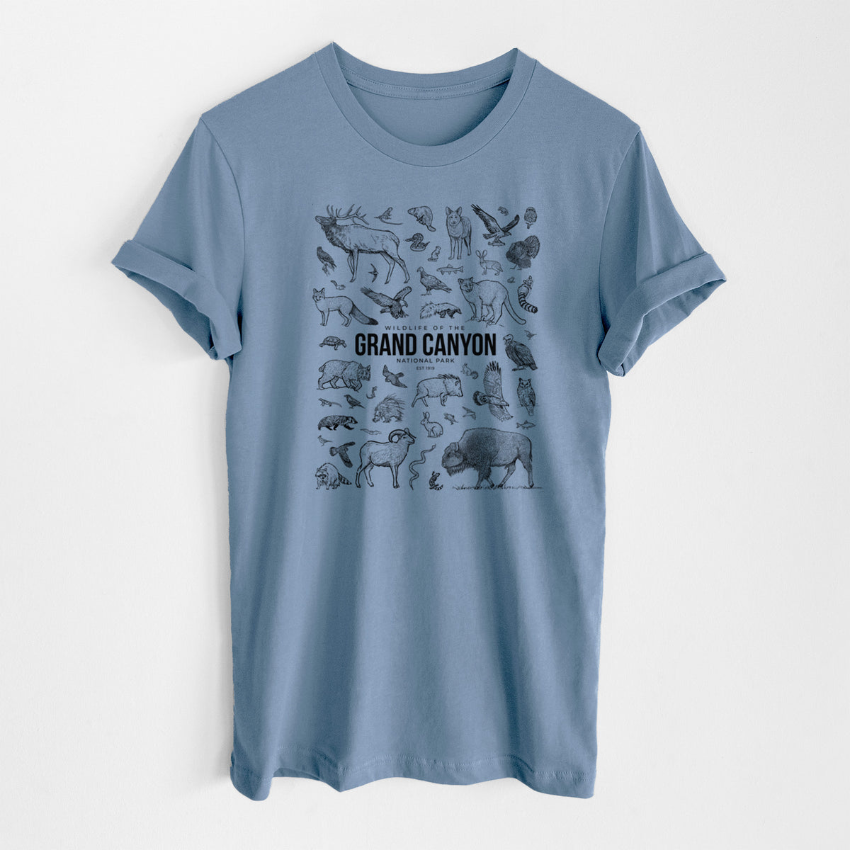 Steel blue lightweight cotton t-shirt laid flat, printed with a collection of black ink wildlife illustrations surrounding the words Grand Canyon National Park.
