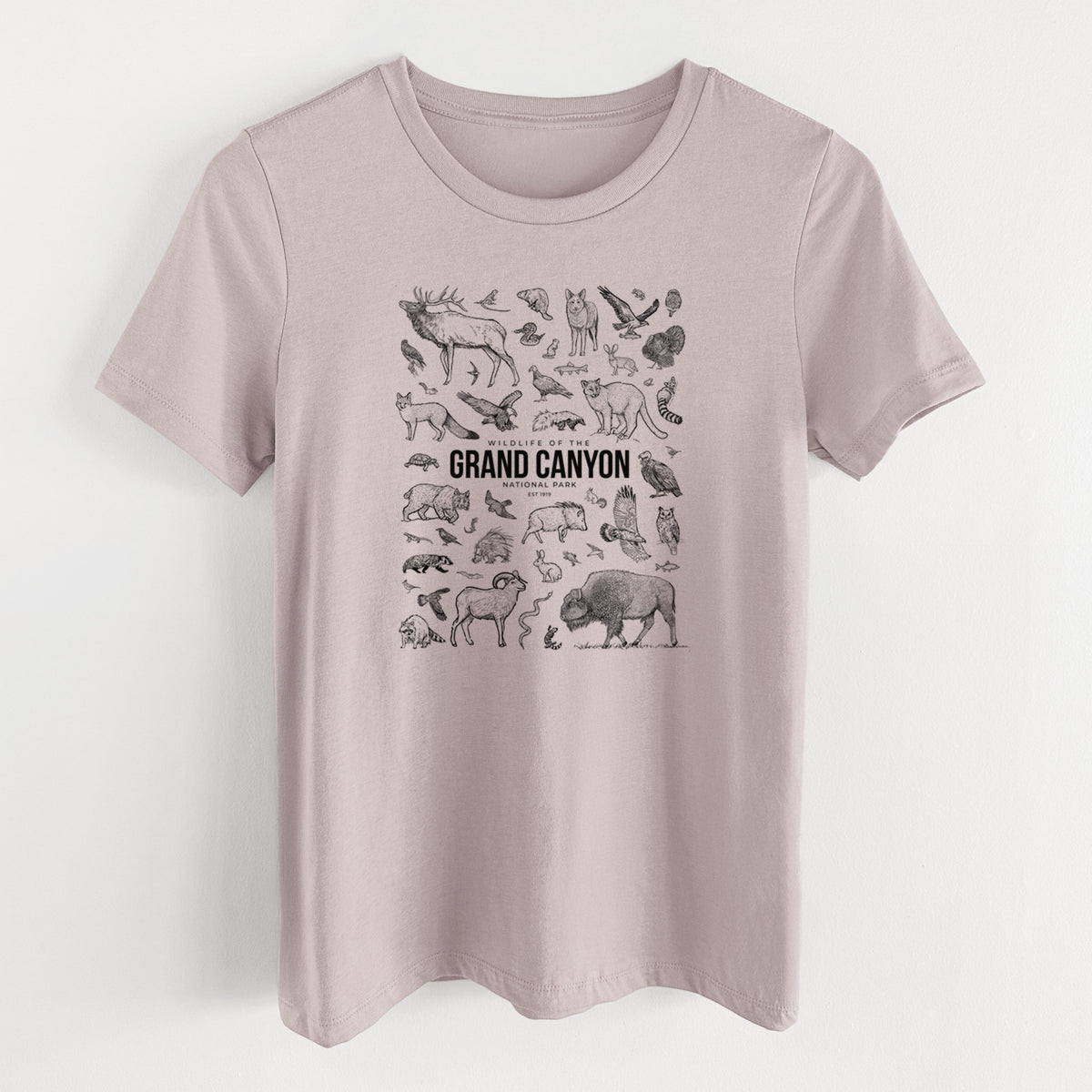 Pink gravel women's relaxed fit cotton t-shirt laid flat, printed with a collection of black ink wildlife illustrations surrounding the words Grand Canyon National Park.