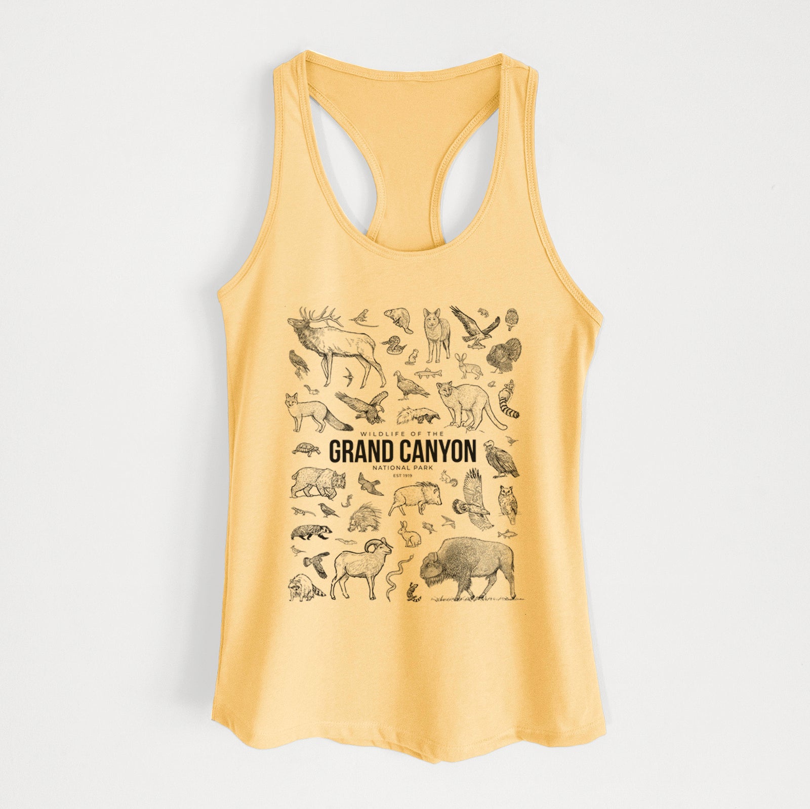 Banana cream women's racerback tank top laid flat, printed with a collection of black ink wildlife illustrations surrounding the words Grand Canyon National Park.