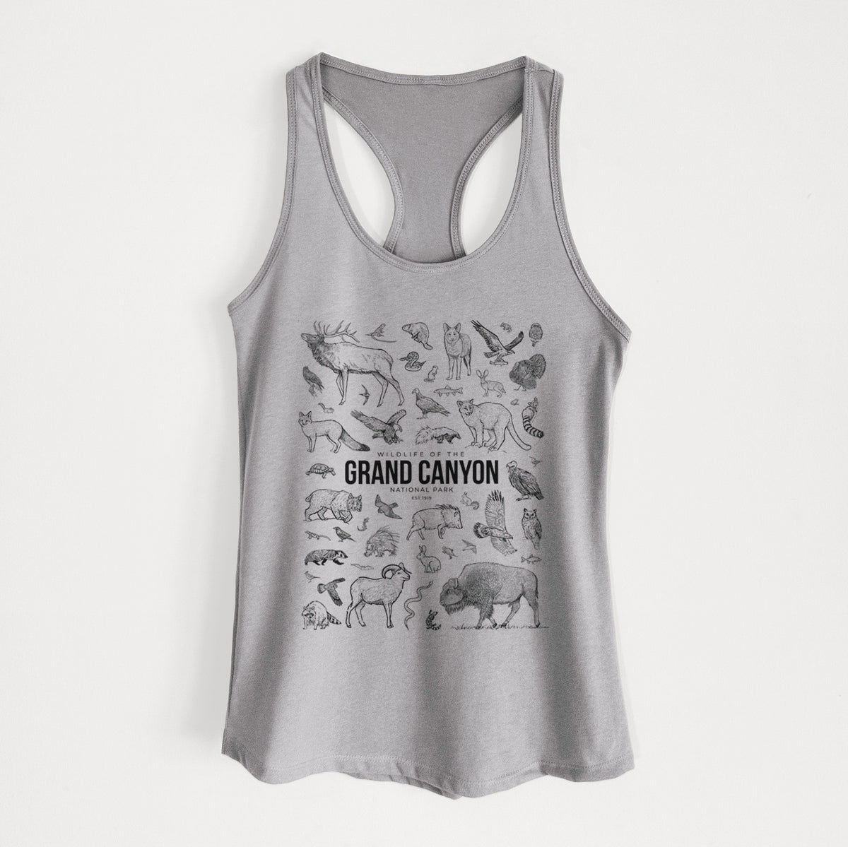 Heather grey women's racerback tank top laid flat, printed with a collection of black ink wildlife illustrations surrounding the words Grand Canyon National Park.