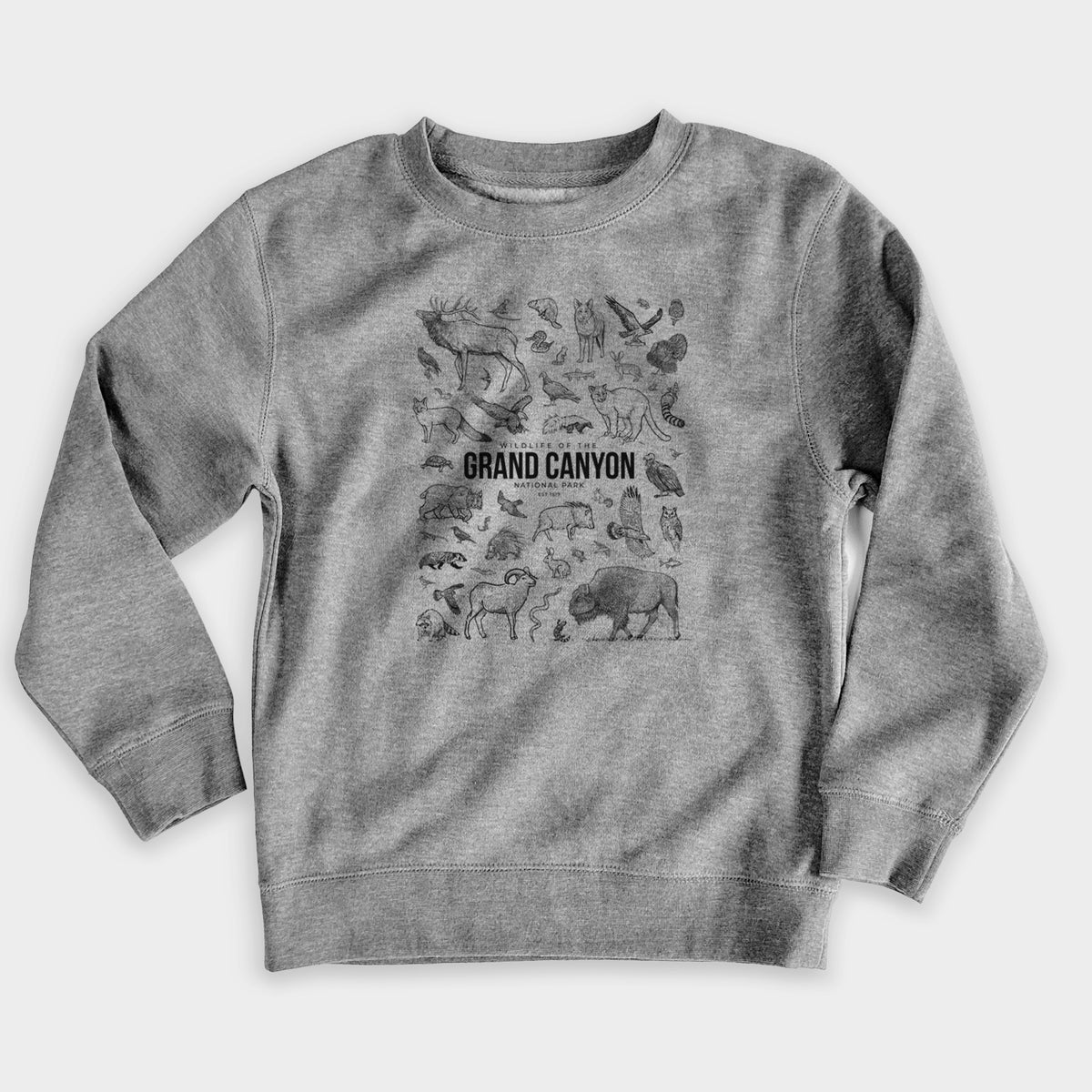 Nickel grey youth crewneck sweatshirt laid flat, printed with a collection of black ink wildlife illustrations surrounding the words Grand Canyon National Park.