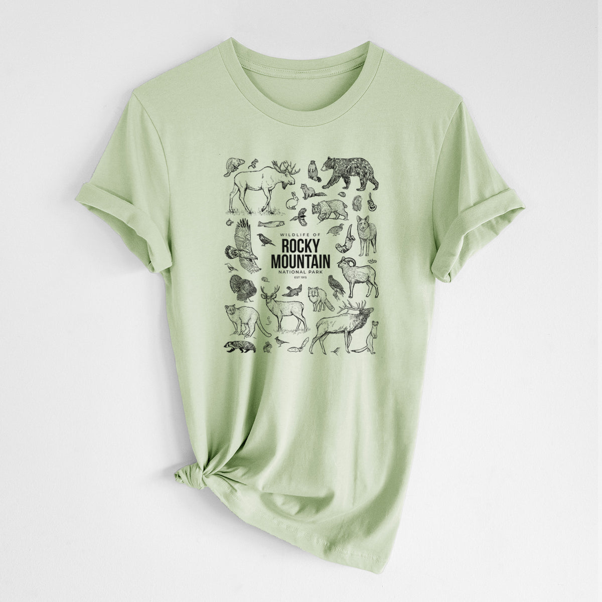 Spring green lightweight cotton t-shirt laid flat with the sleeves rolled, printed with a collection of black ink wildlife illustrations surrounding the words Rocky Mountain National Park.