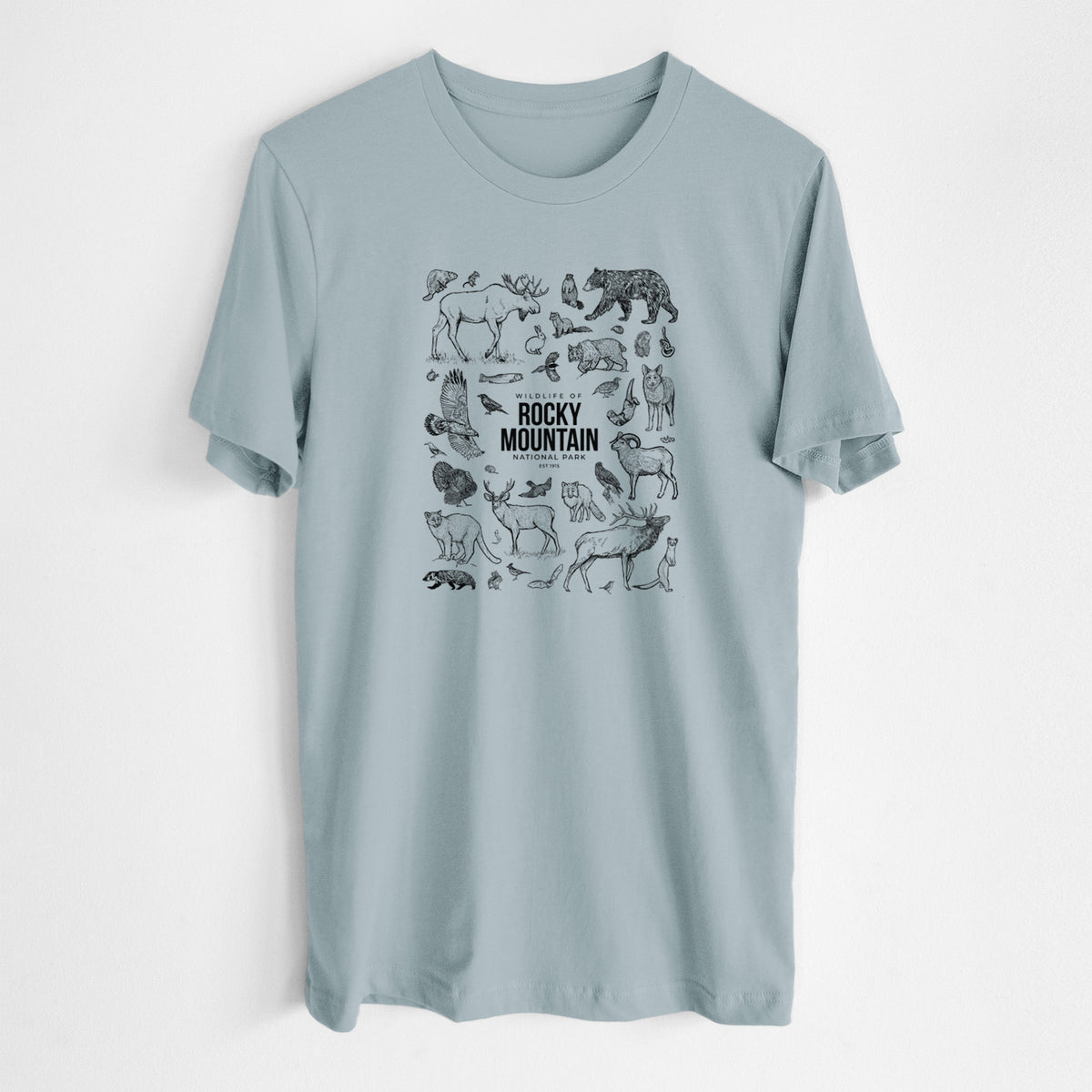 Vintage denim lightweight cotton t-shirt laid flat, printed with a collection of black ink wildlife illustrations surrounding the words Rocky Mountain National Park.