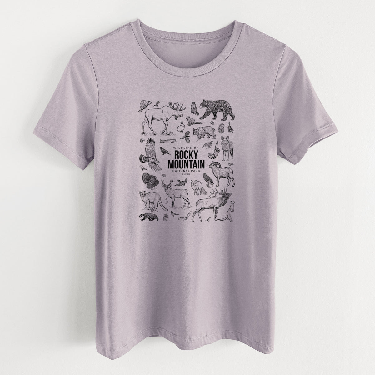 Light violet women's relaxed fit cotton t-shirt laid flat, printed with a collection of black ink wildlife illustrations surrounding the words Rocky Mountain National Park.