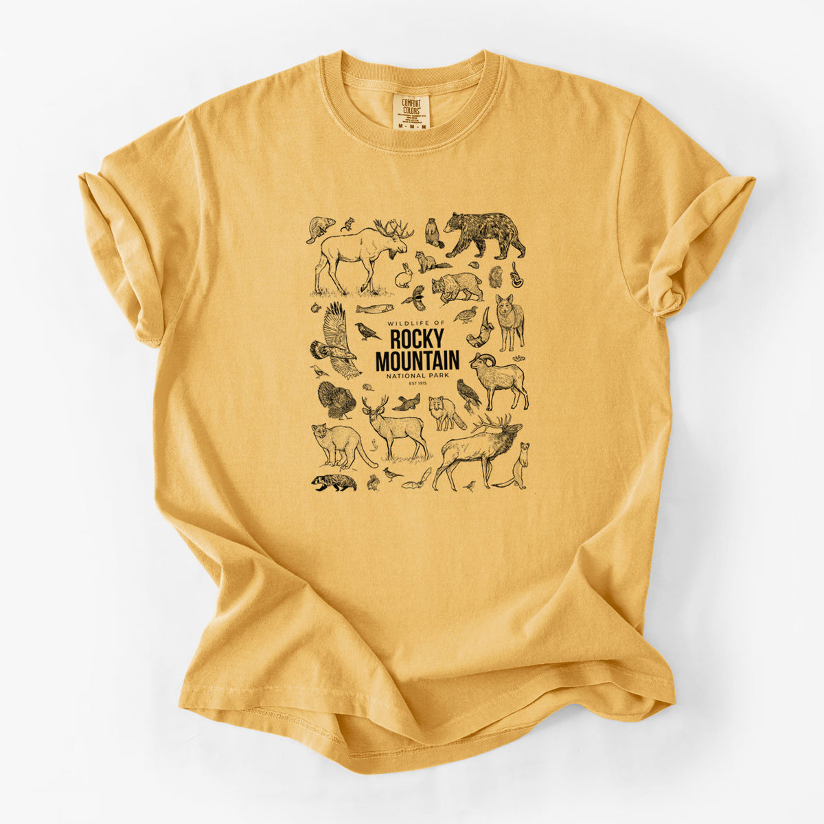 Golden wheat yellow Comfort Colors t-shirt laid flat, printed with a collection of black ink wildlife illustrations surrounding the words Rocky Mountain National Park.