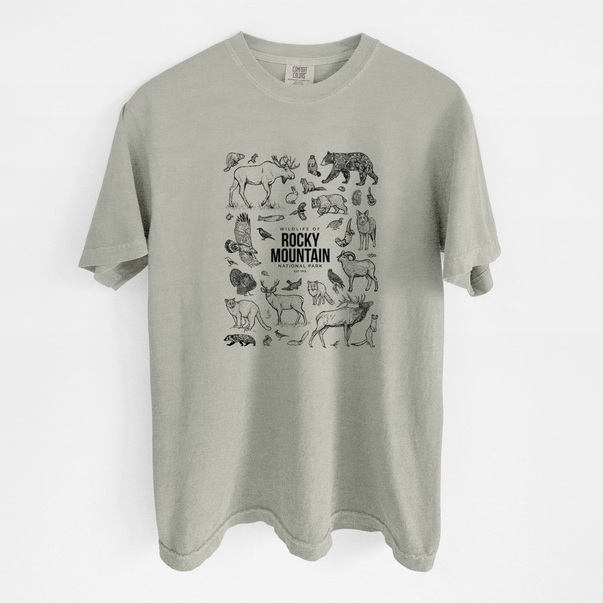 Sandstone beige Comfort Colors t-shirt laid flat, printed with a collection of black ink wildlife illustrations surrounding the words Rocky Mountain National Park.